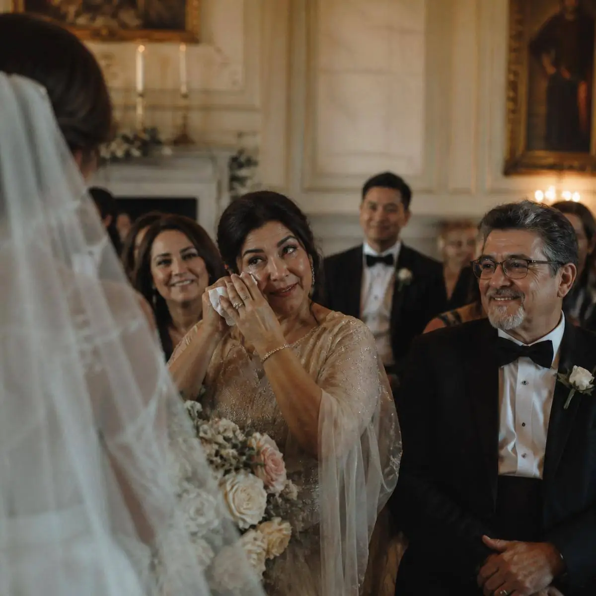 Family members smiling with happy tears during an intimate wedding ceremony
